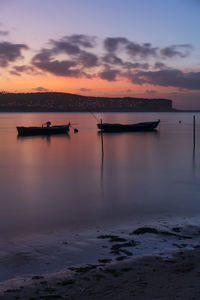 Fishing boats on a river sea at sunset in foz do arelho, portugal