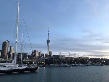 Sailboats in city against sky