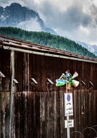 Information sign on wood against sky