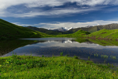 Scenic view of lake and mountains against sky