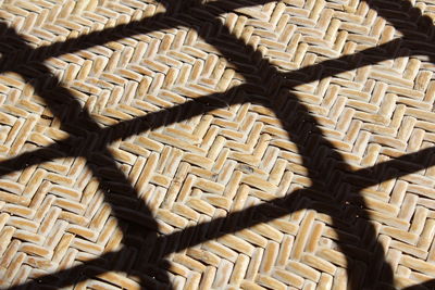 High angle view of shadows on wicker