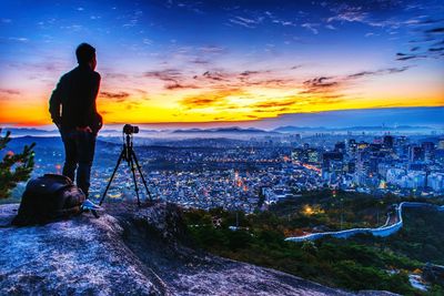 Man photographing at sunset