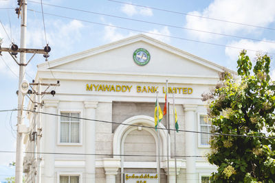 Low angle view of white building against blue sky