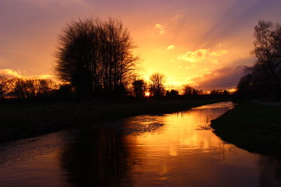 Scenic view of river at sunset