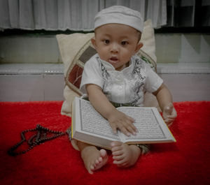 Cute baby girl sitting at home