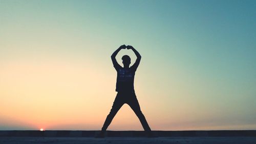 Silhouette man standing against clear sky