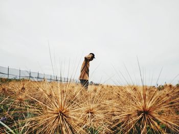 Man standing on field against clear sky