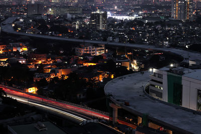 High angle view of illuminated buildings in city at night