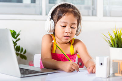 Young woman using laptop at home