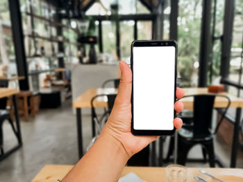 Midsection of person holding smart phone