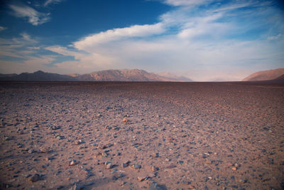 Surface level of barren land against sky