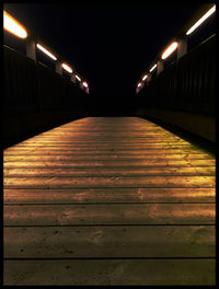 Illuminated walkway at night