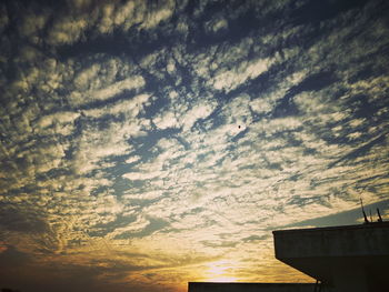 Low angle view of silhouette building against sky