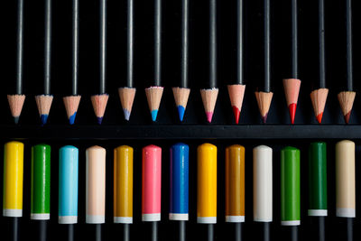 Directly above shot of colored pencils arranged in box