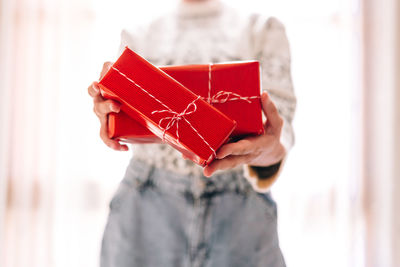 Close-up of woman holding red box