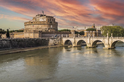 Tevere river and castle sant'angelo in rome with a spectacular sky