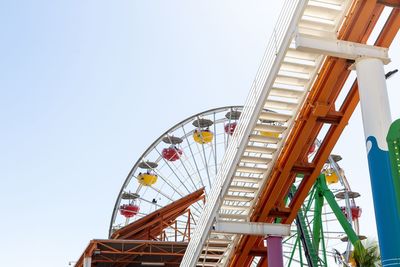 Low angle view of ferris wheel against clear sky