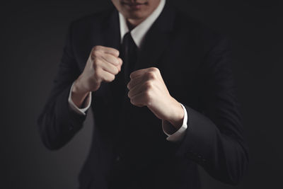 Close-up of hands over black background