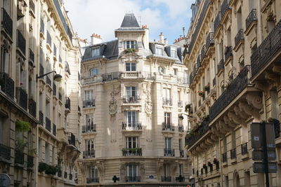 Low angle view of buildings in town against sky