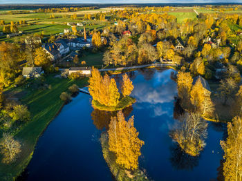 High angle view of autumn trees by lake