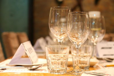 Close-up of wine glasses on table