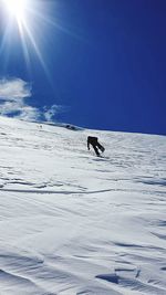 Scenic view of snowcapped mountain against blue sky