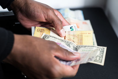 Close-up of human hand holding paper
