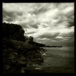 Scenic view of sea against cloudy sky