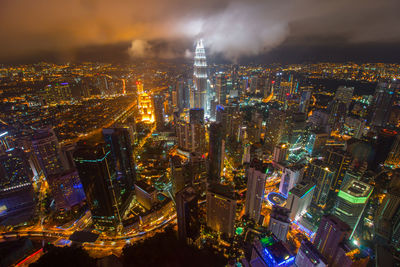 Aerial view of city lit up at night