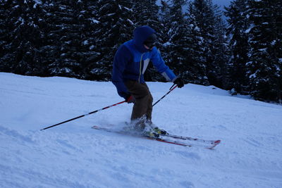 Full length of man skiing on field during winter
