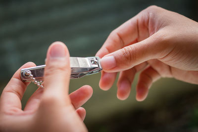 Close-up of hand holding nail clipper