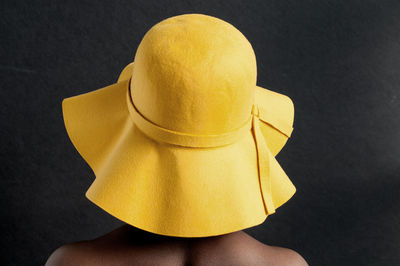 Close-up of a person against yellow background