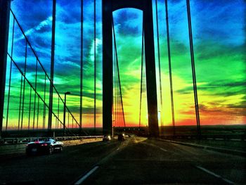 Cars on road at sunset