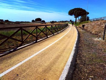 Empty road along countryside landscape