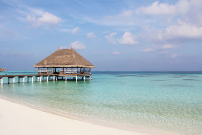 Built structure on beach against sky