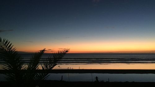 Scenic view of sea against romantic sky at sunset