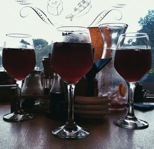 Close-up of wine glasses on table