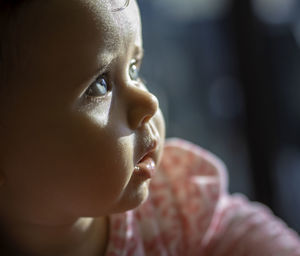 Close-up portrait of cute boy looking away