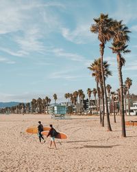 People on beach against sky