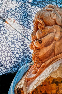Low angle view of statue against blue wall