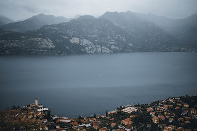 High angle view of townscape by sea against sky