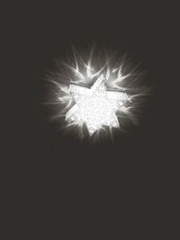 Low angle view of illuminated lights at night