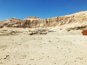 Scenic view of desert against clear blue sky