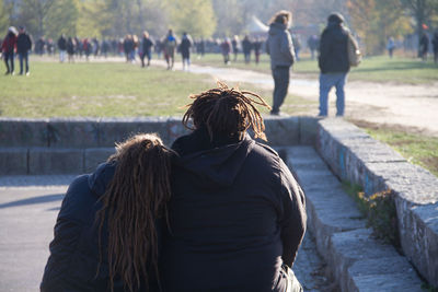 Rear view of people walking outdoors