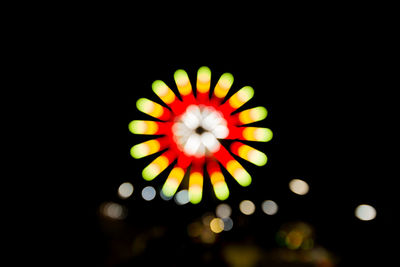 Low angle view of illuminated fireworks against sky at night