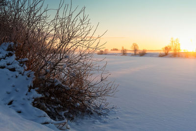 Frozen lake against sky during winter