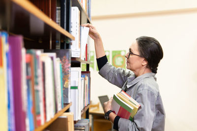 Side view of boy reading book