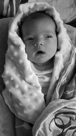 Close-up of cute baby on bed at home