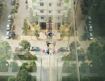 People on road by trees against sky