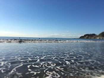 Scenic view of sea against clear blue sky